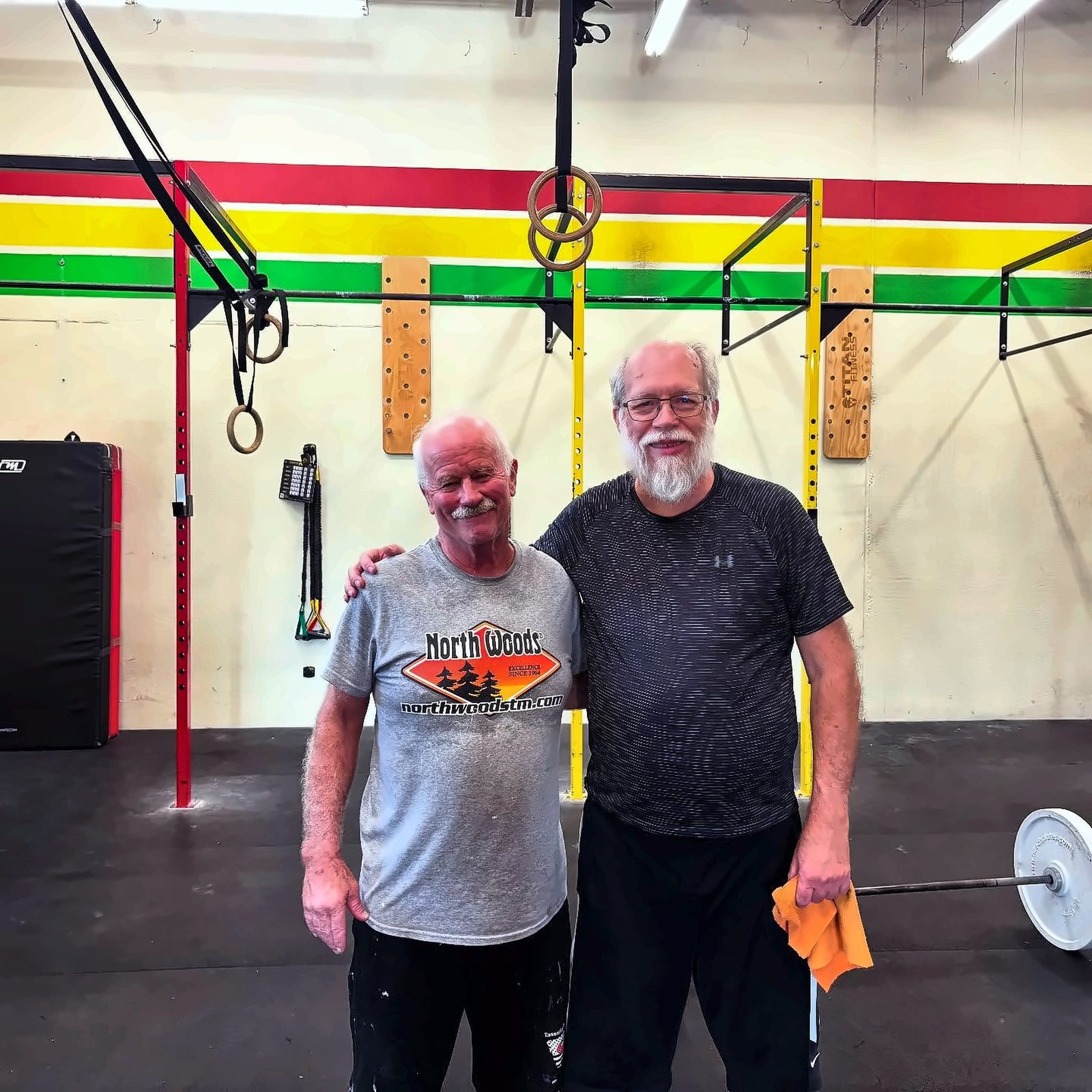 Two MadCity members smiling together in the gym
